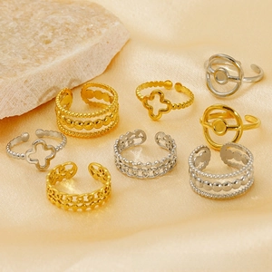 Detail of 8pcs mixed clover and geometric open rings in gold and silver finishes