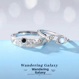 Detailed view of astronaut and rocket space theme couple rings with matte silver texture