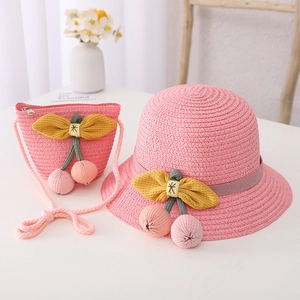 Pink straw sun hat and matching crossbody bag set with cherry and bow accents