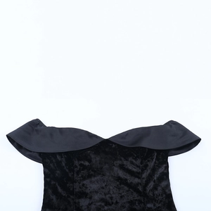 Detailed close-up of velvet black off-shoulder dress featuring satin trim and fine stitching