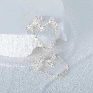 Close-up of S925 hallmark on silver chain tassel earrings with clear crystals