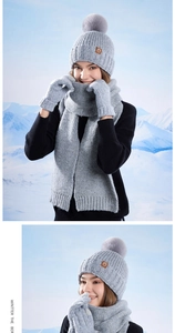 Close-up of knit winter set with faux fur pom-pom hat, scarf and matching gloves