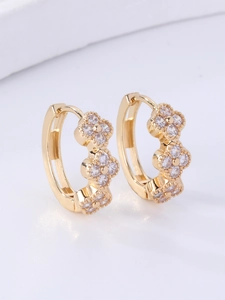 Detail of gold clover hoop earrings with sparkling cubic zirconia pavé inlay