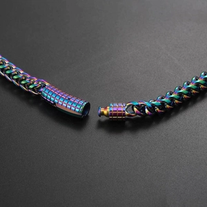 Macro detail of rainbow stainless steel chain featuring secure mechanical spring clasp