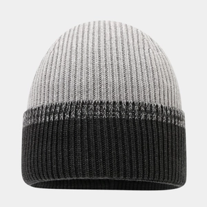 Detail of a two-tone ribbed knit beanie featuring light gray and dark charcoal colors