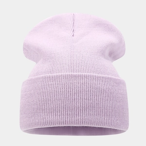 Detailed view of light purple knitted beanie with vertical rib texture and folded cuff
