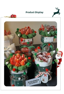 Close-up of Christmas gift wrapping with red plaid paper, green pine branches and red berries