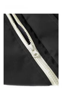 Macro shot of durable black windproof jacket fabric with white heavy-duty resin zipper