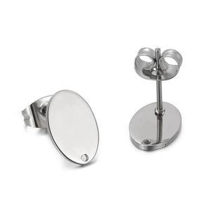 Detail view of silver oval stainless steel stud earrings with polished finish on white background