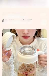 Close-up of heat-resistant glass cup with Lucky in cup print and cream handle