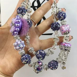 Detail of purple beaded phone charm with rhinestones, faux pearls and butterfly beads