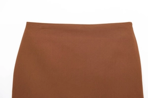 Détail macro du tissu sergé marron caramel et coutures invisibles à la taille
