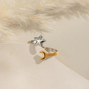 Elegant gold and silver star moon stainless steel open ring on a stone pedestal