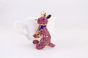 Macro detail of purple kangaroo keychain with sparkling rhinestones and gold-tone finish