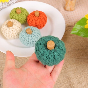 Set of 5 colorful knitted pumpkins with wooden stems for cozy autumn home decorations