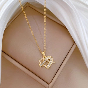 Detailed view of luxury gold titanium steel necklace with sparkling heart zircon pendant
