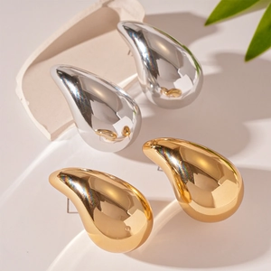 Minimalist gold and silver metallic teardrop earrings with smooth glossy finish