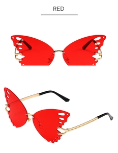Detail of butterfly oversized red gradient sunglasses with elegant gold metal frame