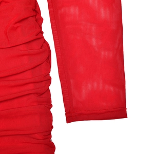 Detailed macro view of the red mesh fabric and ruched texture on the elegant evening dress
