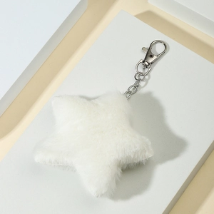 Plush white star keychain pendant with silver metal clasp on minimalist display