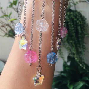 Close-up of crystal butterfly suncatcher pendants with flower and star resin beads