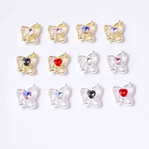 Macro display of hollow heart nail charms with multicolored rhinestones in gold and silver