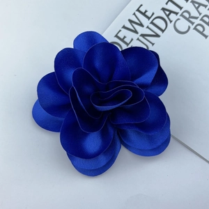 Detail shot of the layered dark blue satin petals on the elegant flower brooch pin
