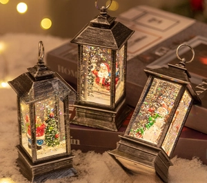 Close-up of vintage silver Christmas lanterns with Santa and snowman scenes and glitter effect