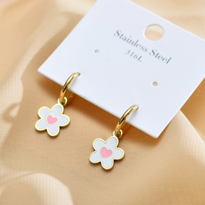 Close-up of 316L stainless steel hoop earrings with white flower and pink heart charms