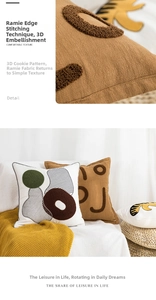 Detail showing the thick textured towel embroidery and rustic linen weave of the pillow cover