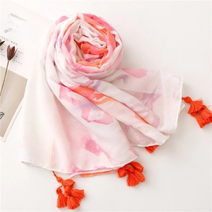 Detail of colorful watercolor floral print on cotton-linen shawl with orange tassels
