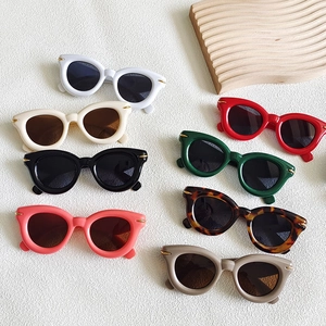 Flat lay of retro chunky cat eye sunglasses in various colors with metallic accents