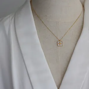 Gold plated titanium steel square necklace with white shell inlay and honeybee motif
