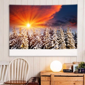 Cozy room setup with a snowy forest sunset wall tapestry hanging on a white wooden wall