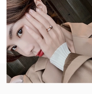 Detail of rose gold double-layer rings with large zircon on woman's ring finger