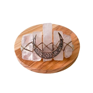 Handmade rose quartz hair clip with bronze moon charm on wooden display stand