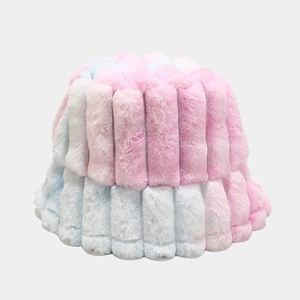 Close-up of tie-dye plush bucket hat showing pink and blue vertical stripe texture