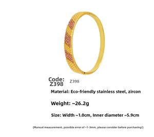 Detail of gold-plated stainless steel bangle with pink zircons and beaded edge
