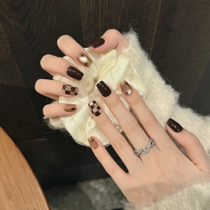 Press-on nails in coffee brown with checkered patterns and star accents for autumn