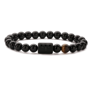 Aries zodiac stretch bracelet with black agate beads and tiger eye stone on white background