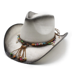 Straw western cowboy sun hat with colorful beads and shells on a white background