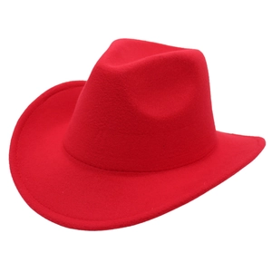 Macro detail of red western cowboy felt hat showing wide brim and classic creased crown