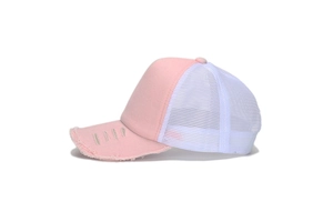 Close-up of pink distressed brim and white mesh panel on a breathable trucker hat