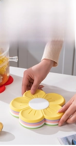 Detail of flower-shaped silicone insulation pads showing stackable storage for kitchen space