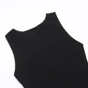 Detail of round neckline and textured black knit fabric on sleeveless dress