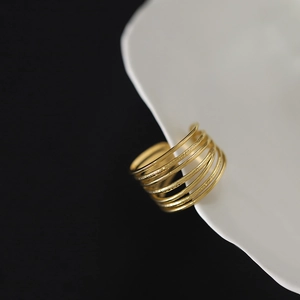 Detailed macro of a 18K gold plated multi-layer spiral ring with matte and glossy textures