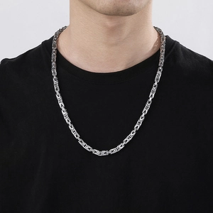 Men's 6mm silver stainless steel Byzantine chain necklace worn by male model on black shirt