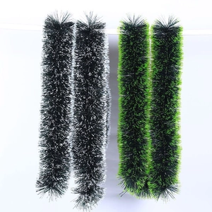 Detail of Christmas tinsel garlands in black-white and green-black fuzzy textures