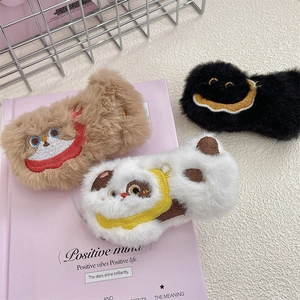 Close-up of cute plush cartoon brooches in brown, spotted and black fluffy textures