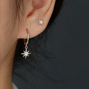 Macro shot of S925 silver star hoop earrings featuring cubic zirconia pavé detailing